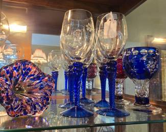 Glass goblets with blue stems and a blown glass flower with stem
