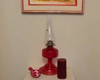 bright wall art, small side table, hurricane lamp and candles