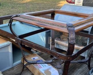 Unusual glass-topped metal table, shaped and colored like leather harness straps