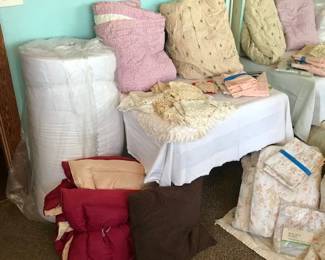 Twin foam bed topper, quilts, down comforter (twin), various linens, crocheted doilies & pieces