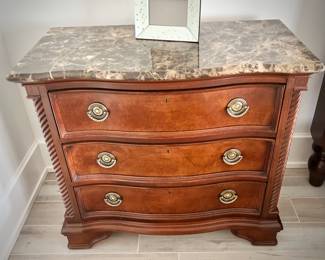 One of two Stanley three-drawer bedside stands with marble tops