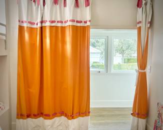 Oversized orange, pink, and white room divider drapes