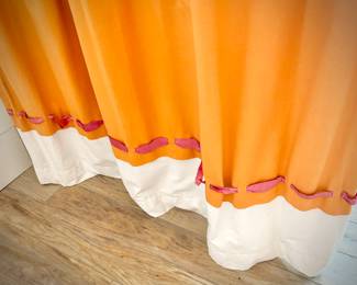 Oversized orange, pink, and white room divider drapes