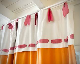 Oversized orange, pink, and white room divider drapes