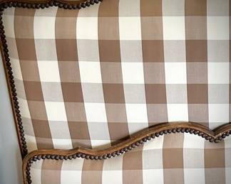 Close up of recently upholstered brown gingham headboard and footboard