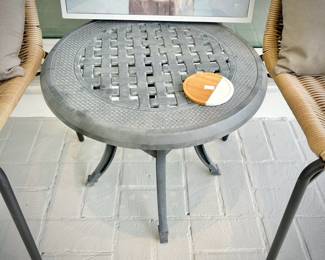 Two woven outdoor chairs and two metal outdoor tables