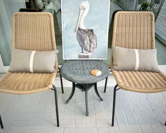 Two woven outdoor chairs and two metal outdoor tables