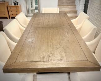 Wood trestle dining table and 8 ivory armchairs