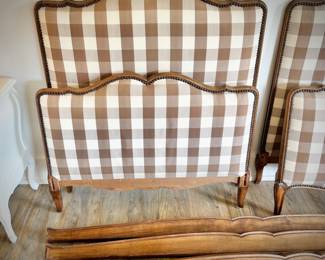 One of two antique twin beds with recently upholstered brown gingham headboard and footboard