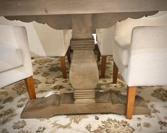 Wood trestle dining table and 8 ivory armchairs