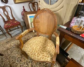 One of a pair of Leopard print, caned back chairs