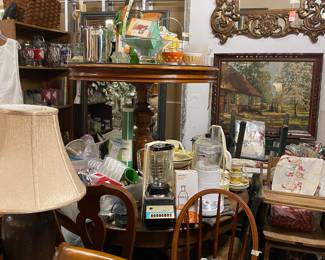 Dozens of mirrors, small round table, 60” padded foot Queen Anne table, vintage junior chair, antique high chair,crock lamp, and hundreds of kitchen ware pieces