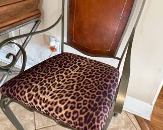Metal chair with leather back and leopard print seat
