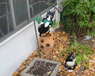 Cement planter, strawberry planter, couple of metal cats, and a welcome hook