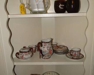 Cups saucers, plates, mugs and bowls, all looking good in  a corner cabinet