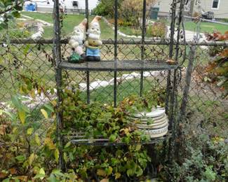 Because every good garden should have a metal bakers rack in it, it is awesome