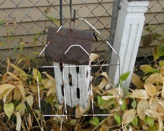 Bird house, and metal thing, and wooden post thing too