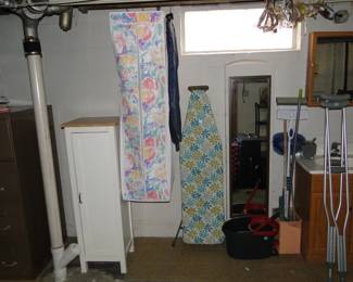 Vintage ironing board, clothing closet, and very nice wooden storage cabinet too