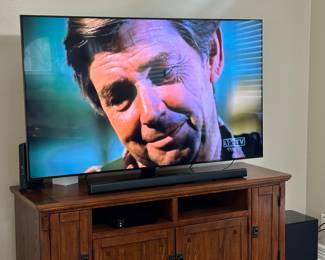 Oak Entertainment Center and Large Flat Screen TV and Sound System.... P.S. John Walton says "Hello Everybody"