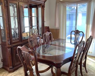 In the dining room you can see the six matching chairs, along with the glass-topped table.  Don't forget the china cabinet against the wall.