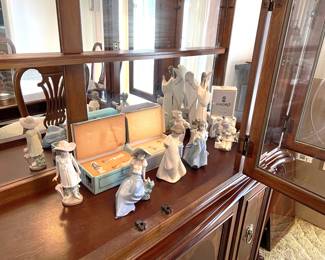 Inside the china cabinet (at least in the photo) are several Lladro figurines.  At the sale you'll need to ask to see them.  Get there on Saturday; these will go fast!