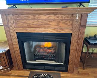 Gas or electric solid wood very nice fire place 