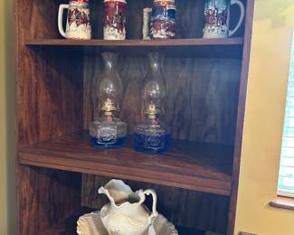 Vintage Budweiser steins, oil lamps, water pitcher & basin, book case