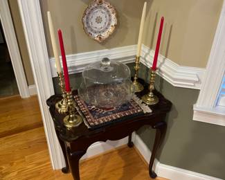 Small side table with vintage brass candlesticks and glass cake stand and cover