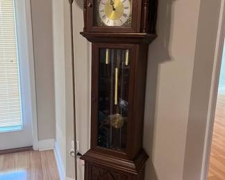 Impressive Grandfather Clock: A timeless piece that will be the centerpiece of any room, showcasing intricate craftsmanship and a rich history, though needs some repair.