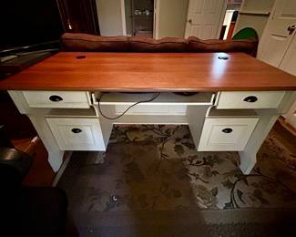 One of two white desks with natural wood tops
