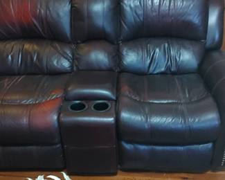 Wonderful double leather recliner with console located in the den 