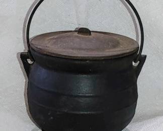 Tiny antique cast iron cauldron with top on three legs and handle