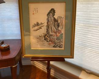 framed Asian art on mahogany art easel