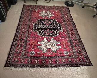 Over a dozen Persian rugs in different patterns and sizes