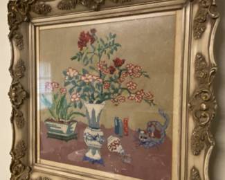 Picture that appears to be hand stitched (crewel) with ornate frame & under glass