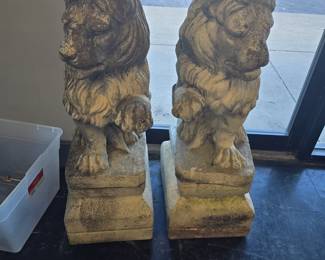 Large concrete lions on pedestals