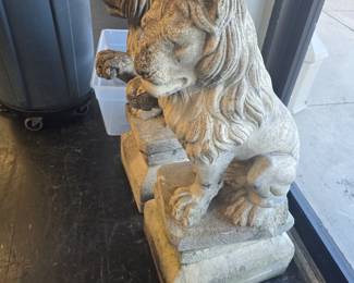 Large concrete lions on pedestals