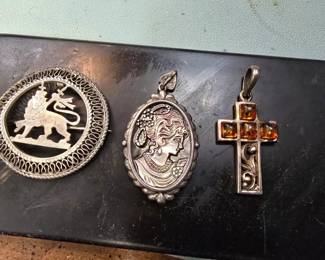 Sterling silver brooch and pendants.