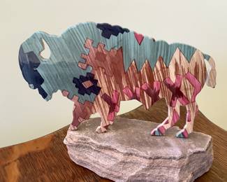 Southwestern metal bison sculpture mounted on stone base