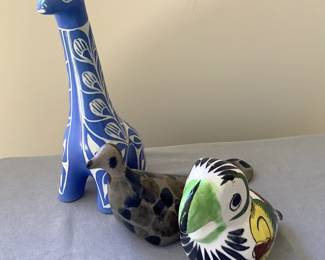 Signed pottery birds and giraffe