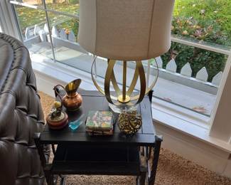 Side/accent table with metal base and wood surface; nice selection of home decor throughout the house.