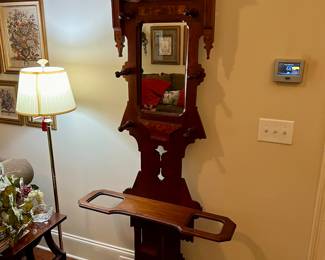 Antique hall tree with original mirror and cast iron plates on the bottom