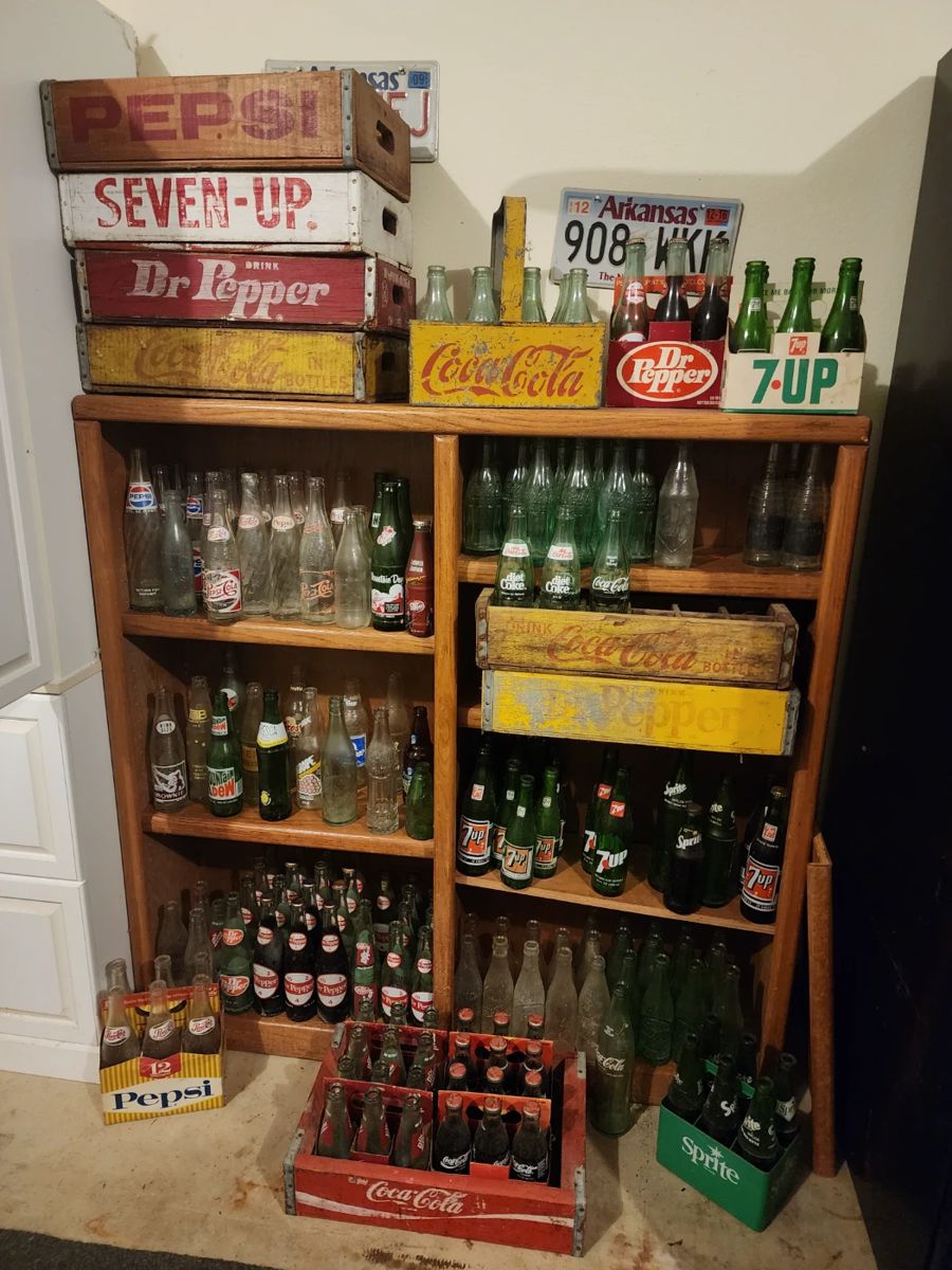 Bottle collection with wooden crates.  Top Coca Cola basket is a metal basket with bottles