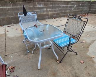 Two metal patio chairs with small table