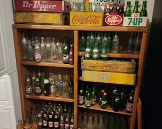 Bottle collection with wooden crates.  Top Coca Cola basket is a metal basket with bottles