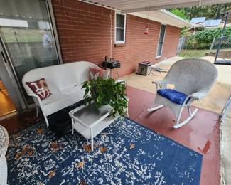 Outdoor wicker settee, coffee table, and rocker