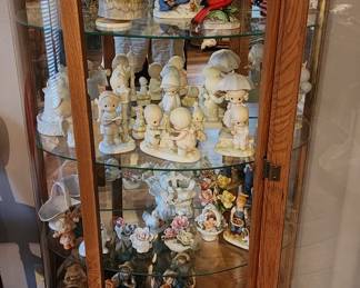 Curio cabinet with Precious Moment and other figurines