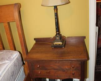 old sewing machine cabinet converted to lamp table