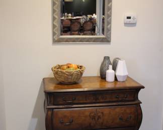 Pair of bombe chests & "Uttermost" silver gilt mirrors