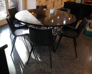 Round granite top dining table with 6 Arhaus faux leather chairs